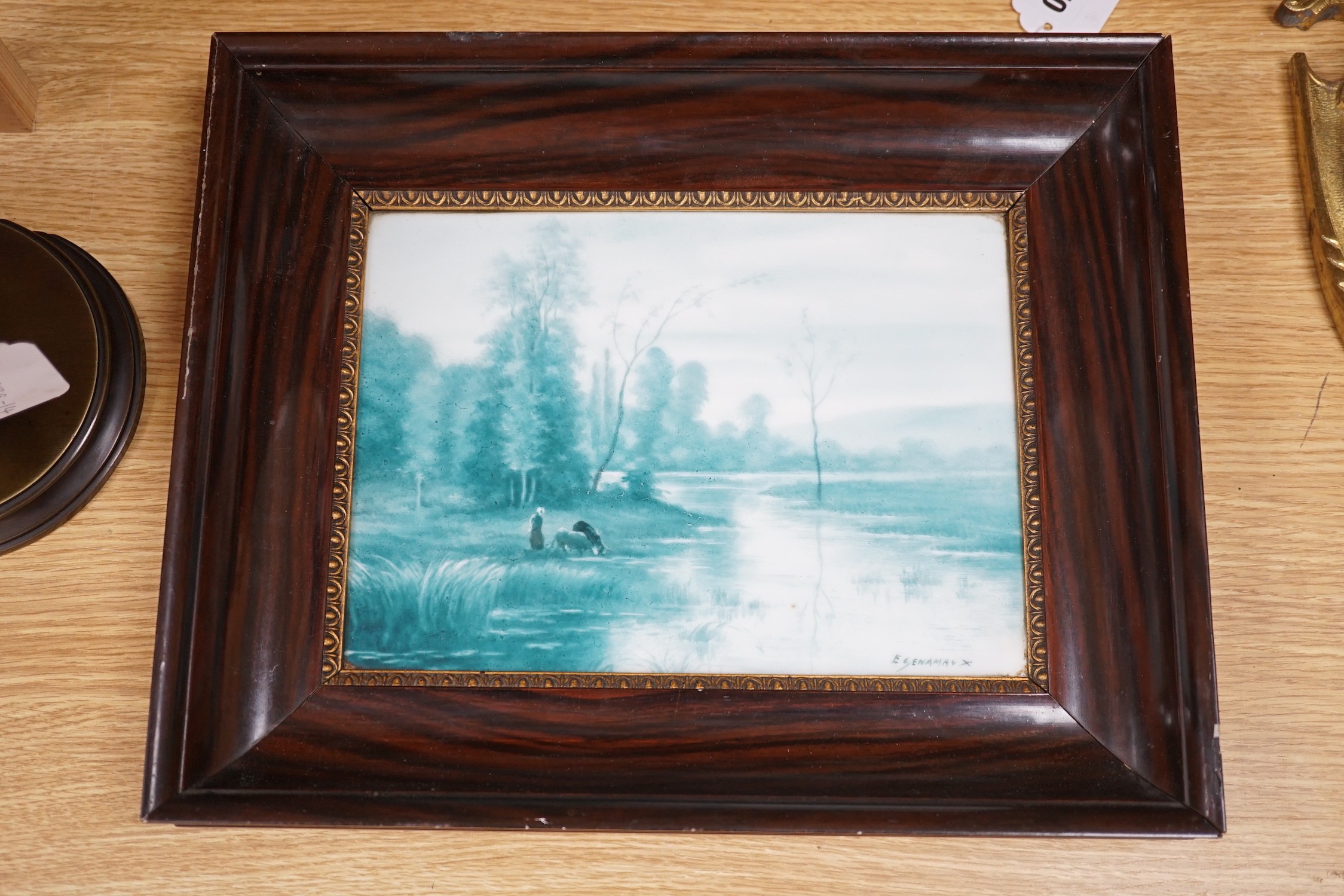 A French porcelain landscape plaque, indistinctly signed ‘E GENAMAN’